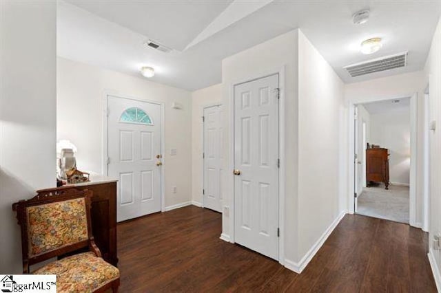 foyer entrance with wood finished floors, visible vents, and baseboards