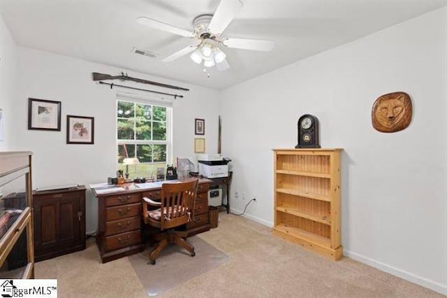 office space with a ceiling fan, light colored carpet, visible vents, and baseboards