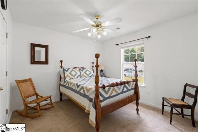 bedroom featuring light carpet, visible vents, baseboards, and a ceiling fan