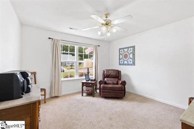 sitting room with carpet, visible vents, ceiling fan, and baseboards