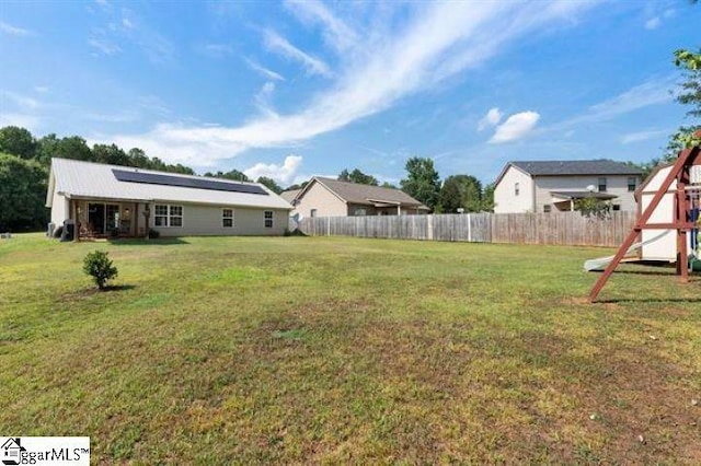 view of yard featuring a playground and fence