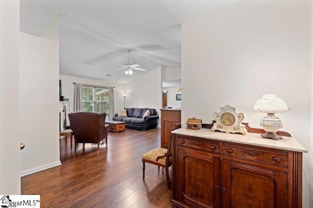 interior space with lofted ceiling, ceiling fan, and dark wood-style flooring