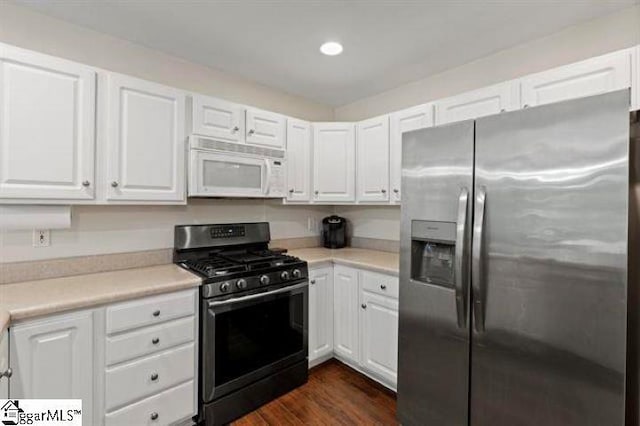 kitchen with light countertops, appliances with stainless steel finishes, and white cabinetry