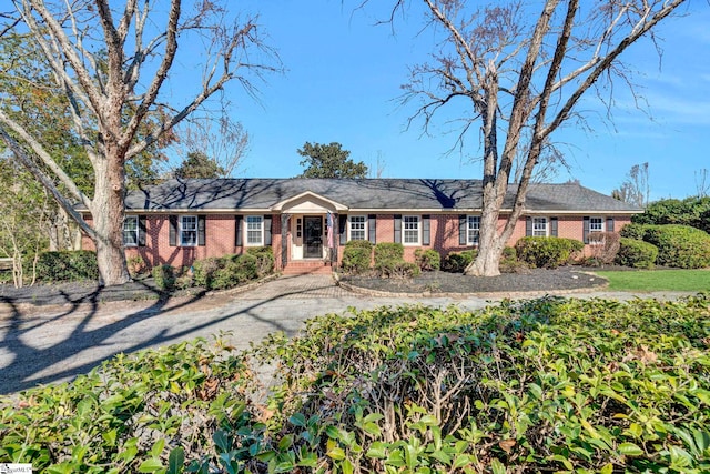 ranch-style house featuring brick siding