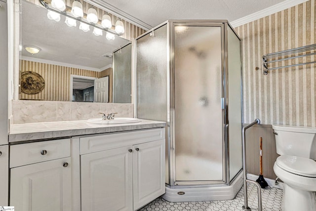 bathroom featuring toilet, vanity, a shower stall, wallpapered walls, and crown molding