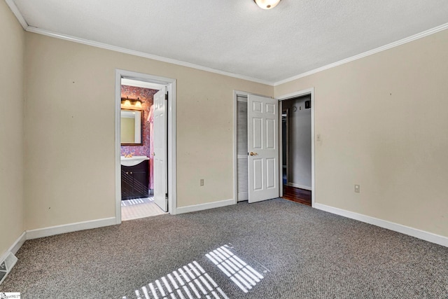 unfurnished bedroom with carpet floors, crown molding, and baseboards