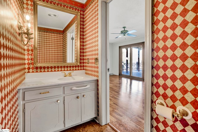 bathroom featuring ornamental molding, visible vents, vanity, and wallpapered walls