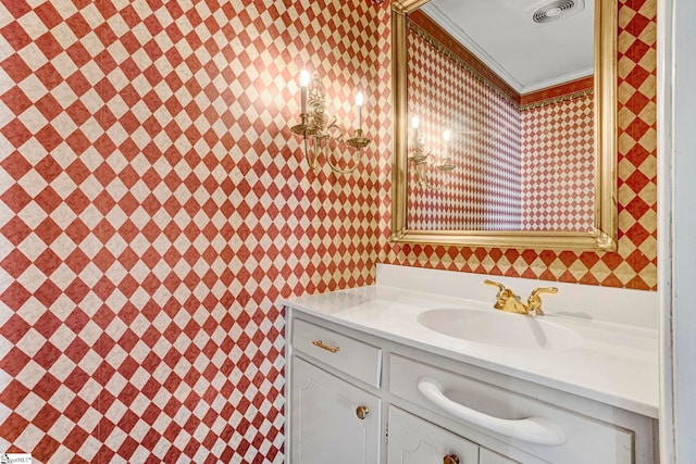 bathroom with visible vents, crown molding, and vanity