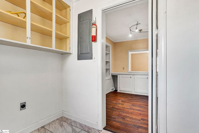 laundry area with laundry area, baseboards, electric panel, electric dryer hookup, and crown molding