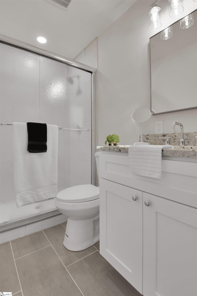 bathroom featuring a stall shower, visible vents, toilet, tile patterned flooring, and vanity