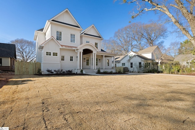 view of front facade featuring fence, board and batten siding, and a front yard