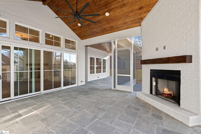 view of patio / terrace featuring ceiling fan and a fireplace