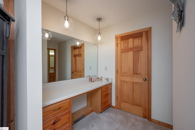 bathroom with baseboards, visible vents, vanity, and a textured ceiling