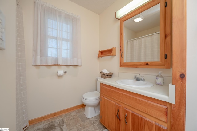 full bath with curtained shower, vanity, toilet, and baseboards