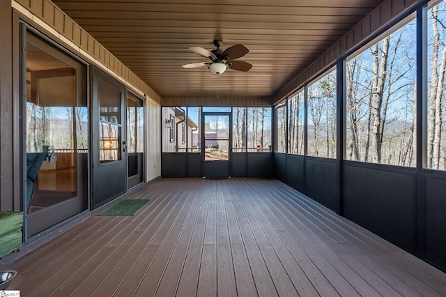 unfurnished sunroom featuring a ceiling fan