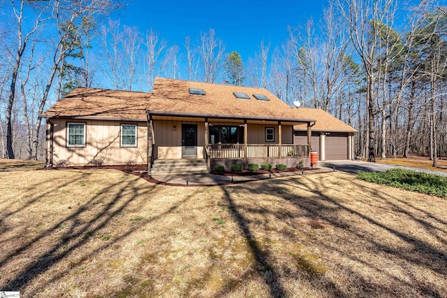 ranch-style house with a porch, a garage, an outdoor structure, driveway, and a front lawn