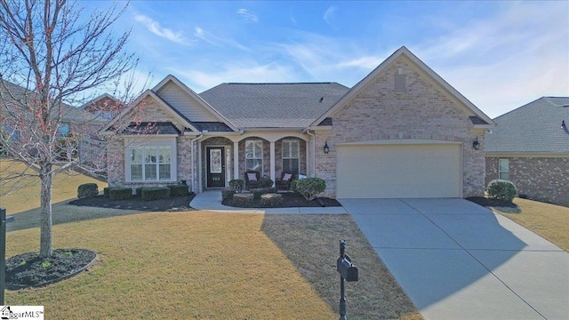 view of front facade with a front lawn, an attached garage, brick siding, and concrete driveway