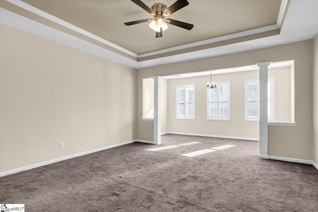 empty room featuring crown molding, baseboards, carpet floors, ceiling fan with notable chandelier, and a raised ceiling