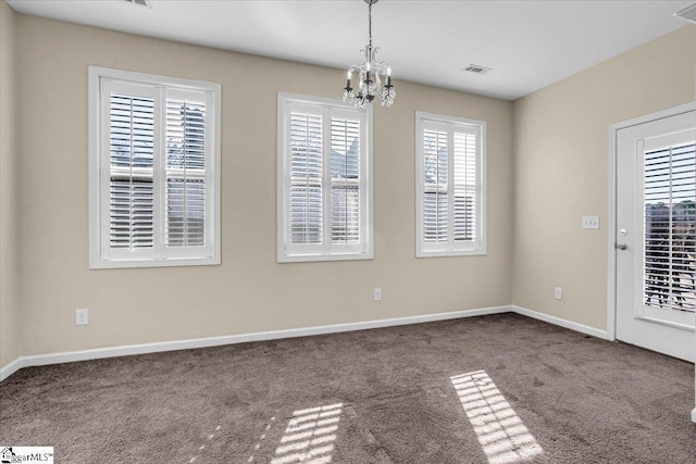 unfurnished dining area with a notable chandelier, carpet flooring, visible vents, and baseboards