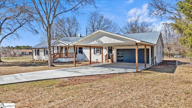 view of front of home with driveway, crawl space, fence, and metal roof