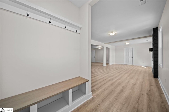 mudroom featuring baseboards, visible vents, and light wood finished floors