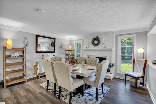 dining space featuring a textured ceiling, dark wood finished floors, and crown molding