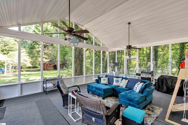 sunroom with ceiling fan and vaulted ceiling