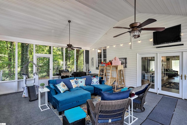 sunroom / solarium featuring lofted ceiling, a wealth of natural light, and a ceiling fan