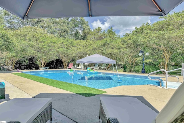 outdoor pool with a patio and a gazebo