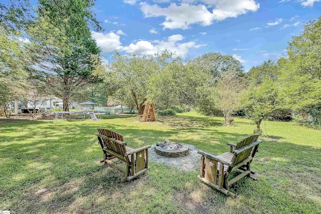 view of yard with a fire pit