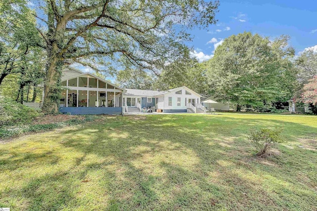 exterior space with a sunroom and a front yard