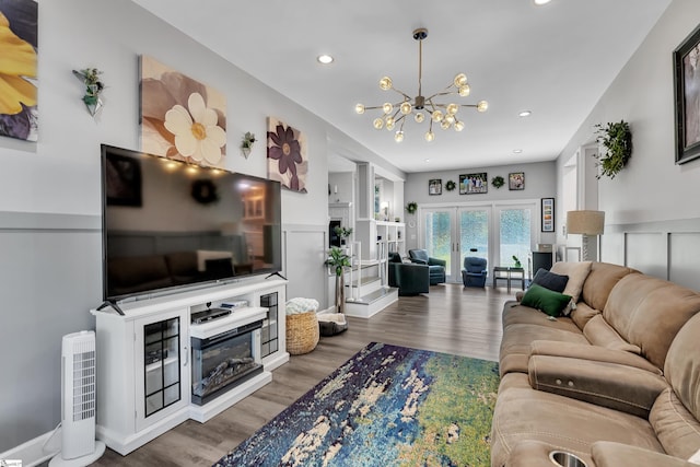 living area with recessed lighting, a notable chandelier, wood finished floors, and french doors