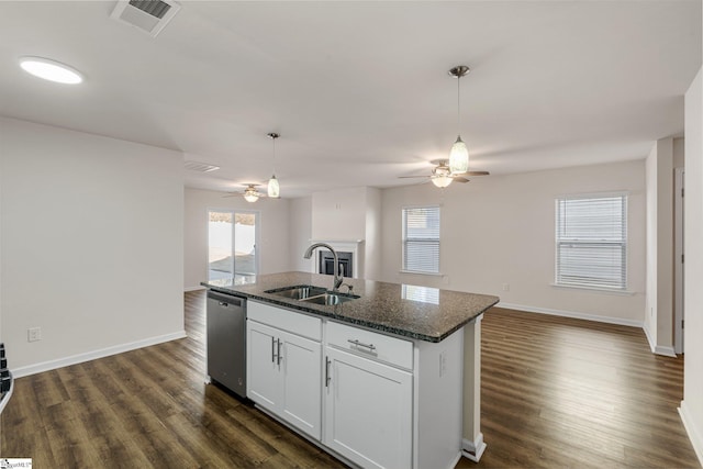 kitchen with a sink, visible vents, open floor plan, and stainless steel dishwasher