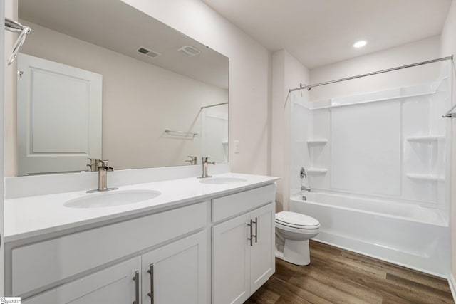 bathroom with visible vents, a sink, toilet, and wood finished floors