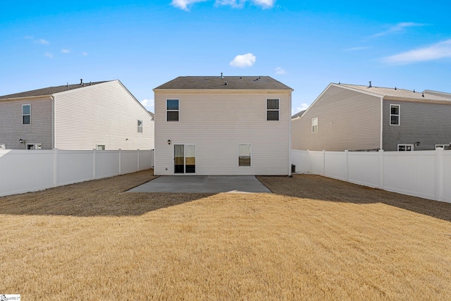 rear view of property with a patio area, a yard, and a fenced backyard