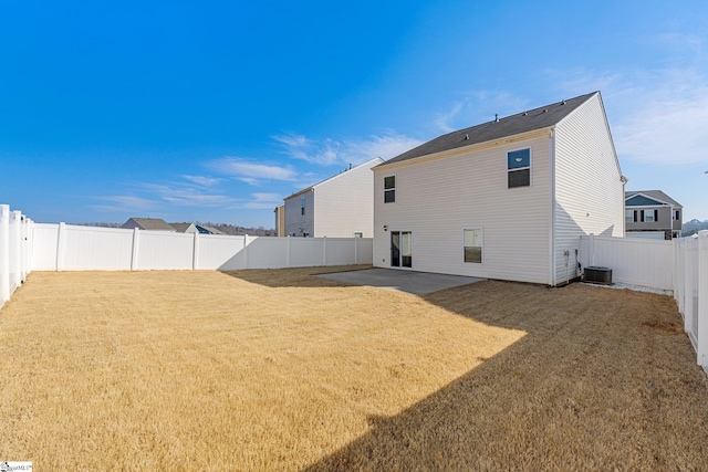 rear view of property with a yard, a patio, and a fenced backyard