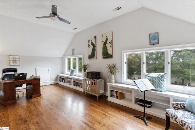 home office with baseboards, visible vents, lofted ceiling, ceiling fan, and wood finished floors