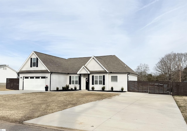 view of front of house with driveway, roof with shingles, and fence