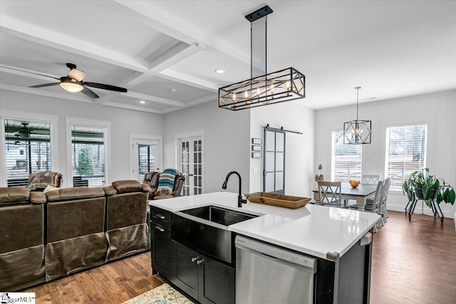 kitchen with dishwasher, a barn door, open floor plan, and dark wood-style floors