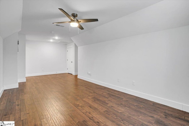 additional living space with wood-type flooring, visible vents, ceiling fan, and baseboards