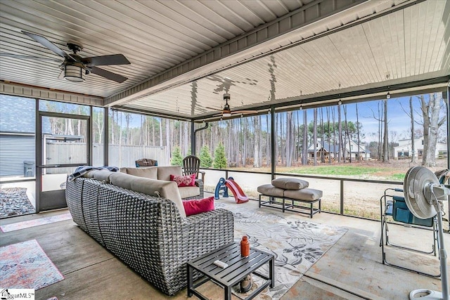 sunroom featuring a ceiling fan