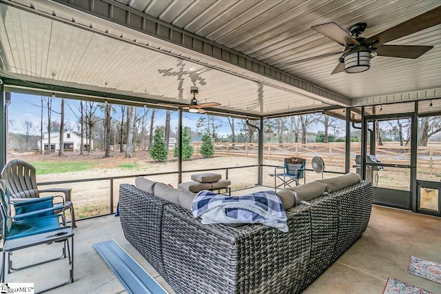 sunroom / solarium featuring ceiling fan