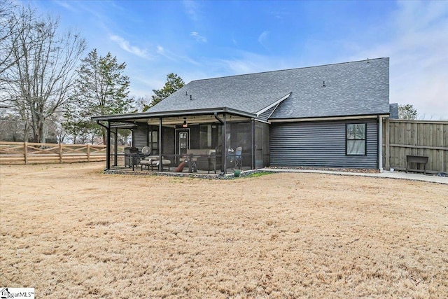 back of property featuring roof with shingles, fence, and a sunroom