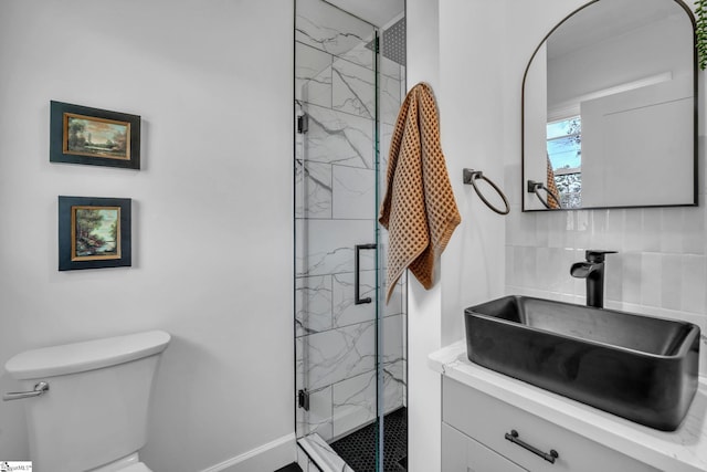 bathroom featuring toilet, vanity, and a marble finish shower