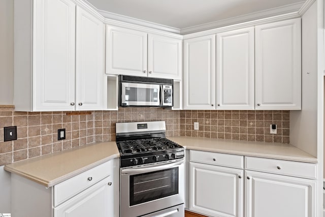 kitchen featuring appliances with stainless steel finishes, white cabinets, and light countertops