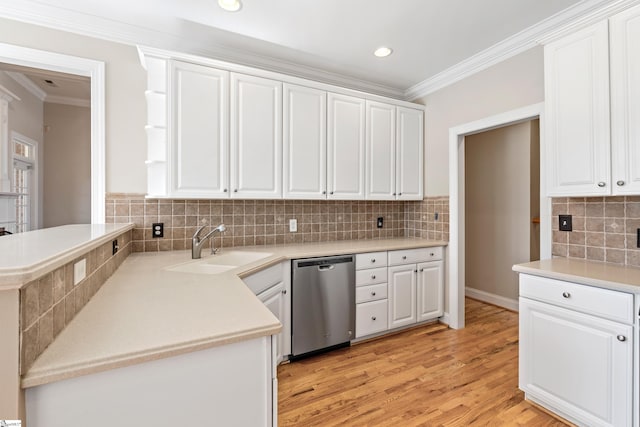 kitchen with a sink, crown molding, white cabinetry, and stainless steel dishwasher