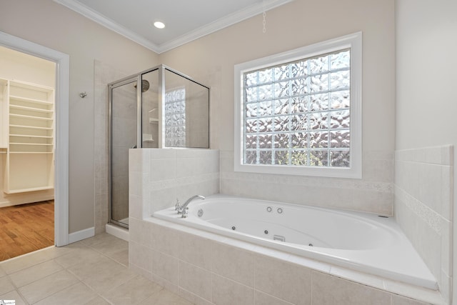 bathroom with a spacious closet, tile patterned floors, a whirlpool tub, a stall shower, and crown molding