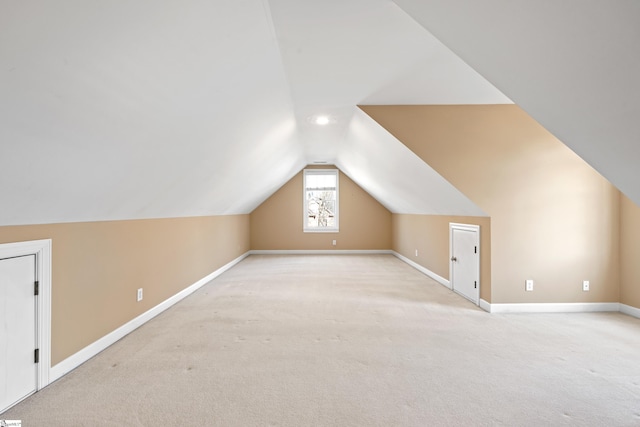 bonus room featuring light carpet, lofted ceiling, and baseboards