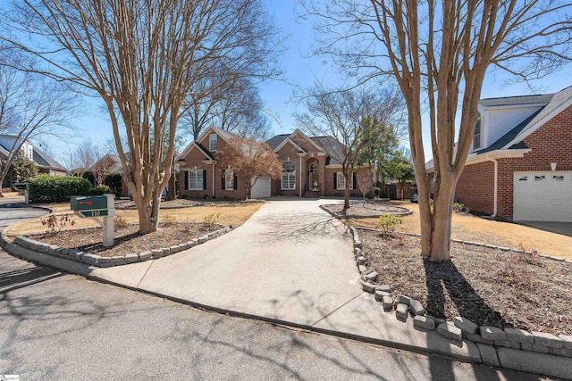 view of front facade featuring a garage, driveway, and brick siding