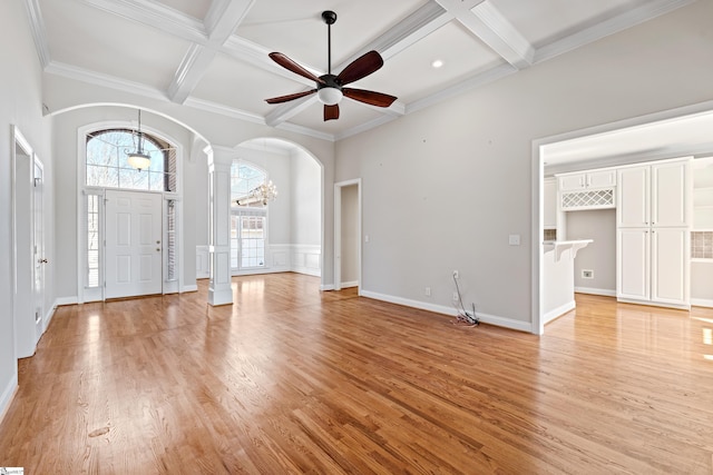 entrance foyer with arched walkways, coffered ceiling, decorative columns, and light wood-style flooring